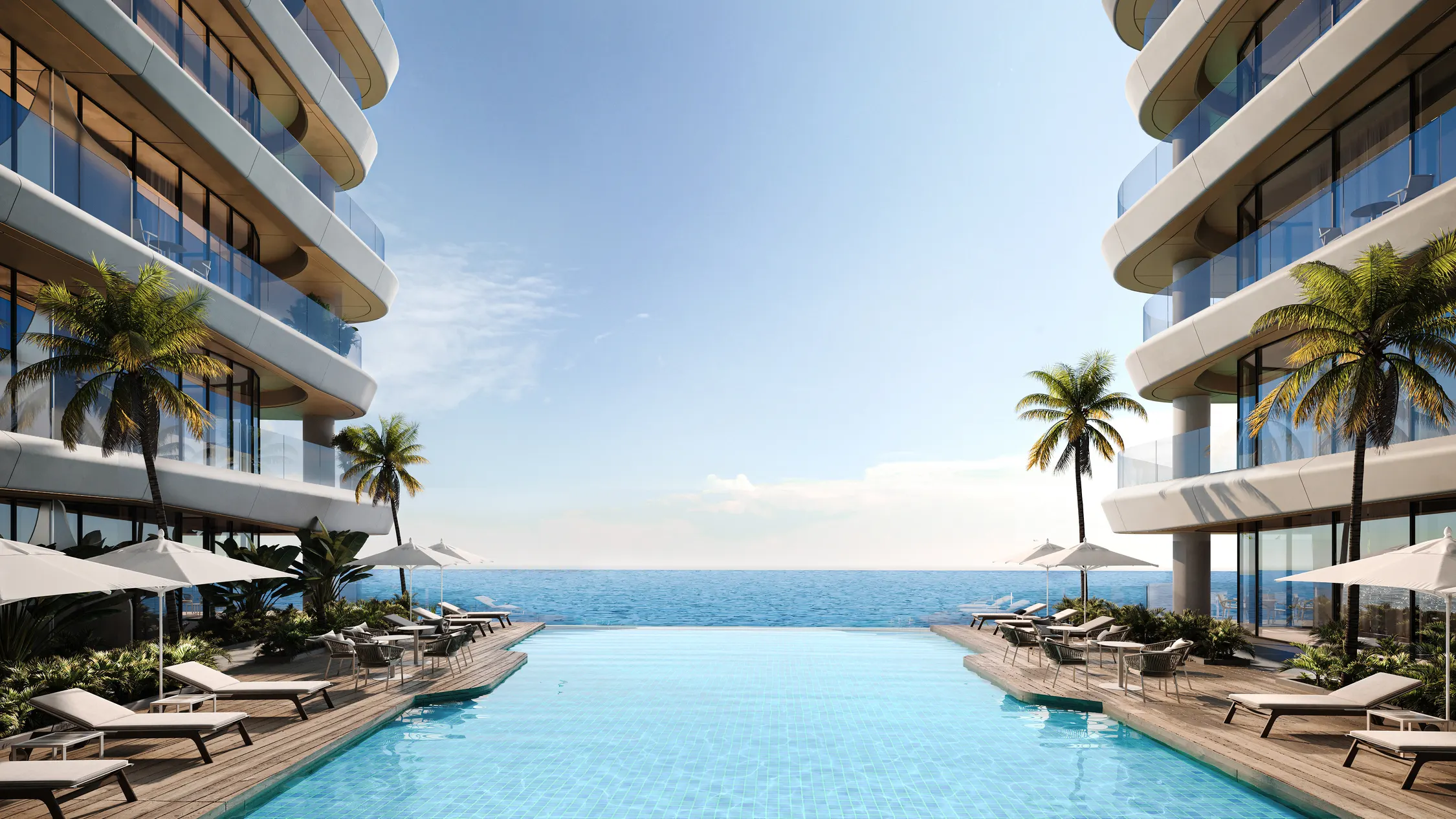 Piscina central de Gianfranco Ferré Residences entre las dos alas del edificio, con palmeras y vistas abiertas al Golfo Pérsico