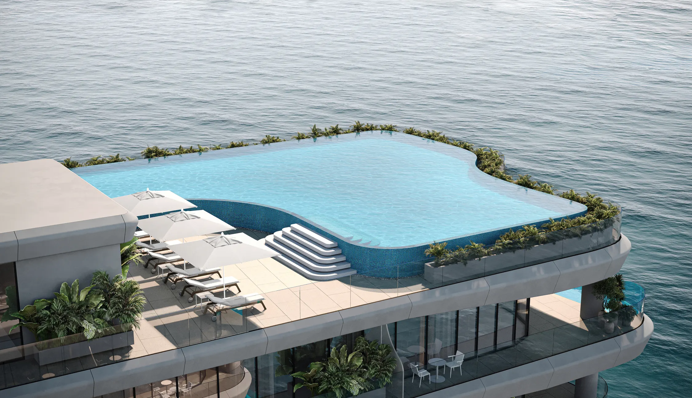 Piscina en terraza de Gianfranco Ferré Residences en voladizo sobre el mar, con tumbonas y sombrillas