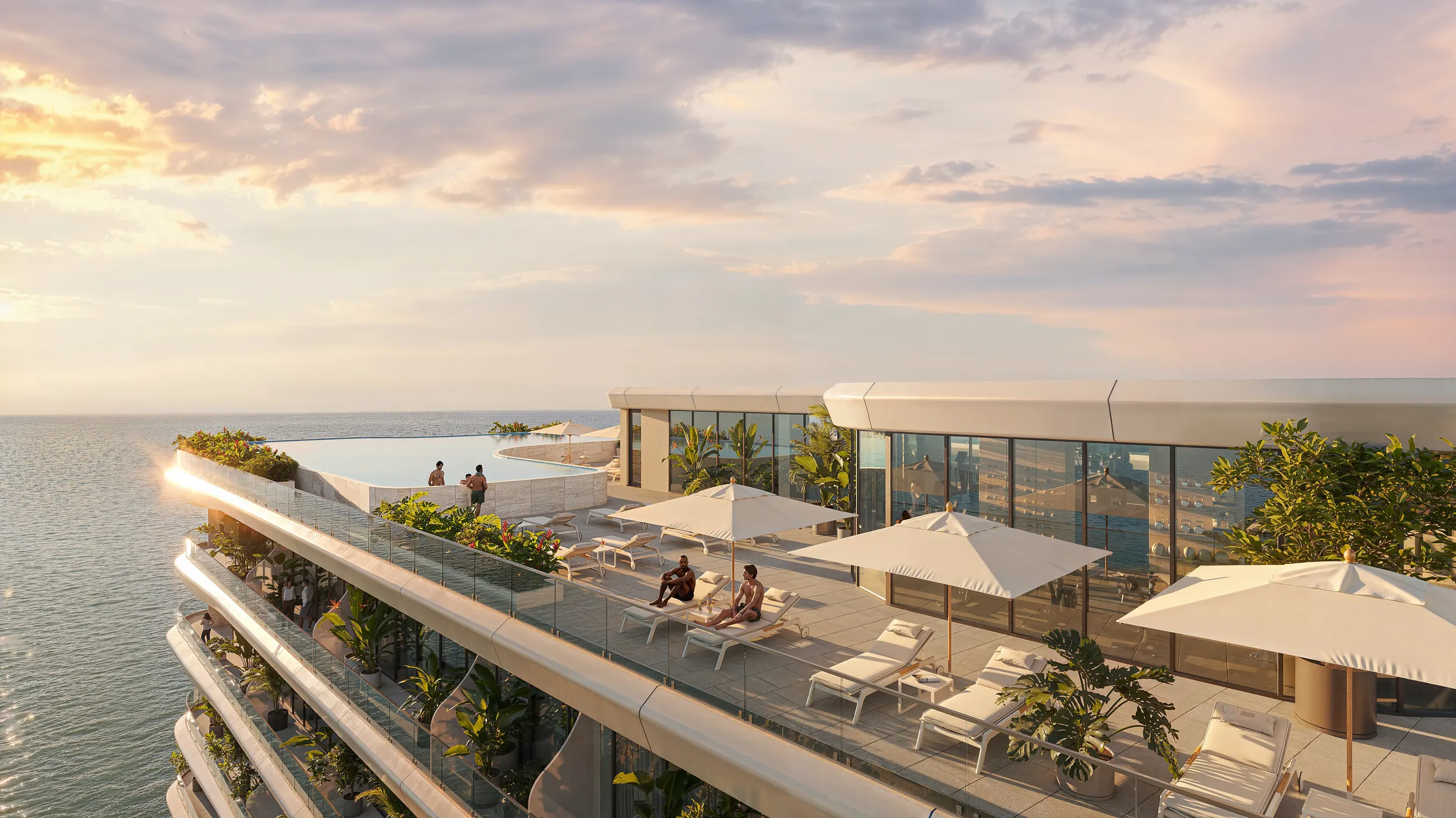 Terraza en la azotea de Gianfranco Ferré Residences con piscina infinita, tumbonas y vegetación al atardecer sobre el mar