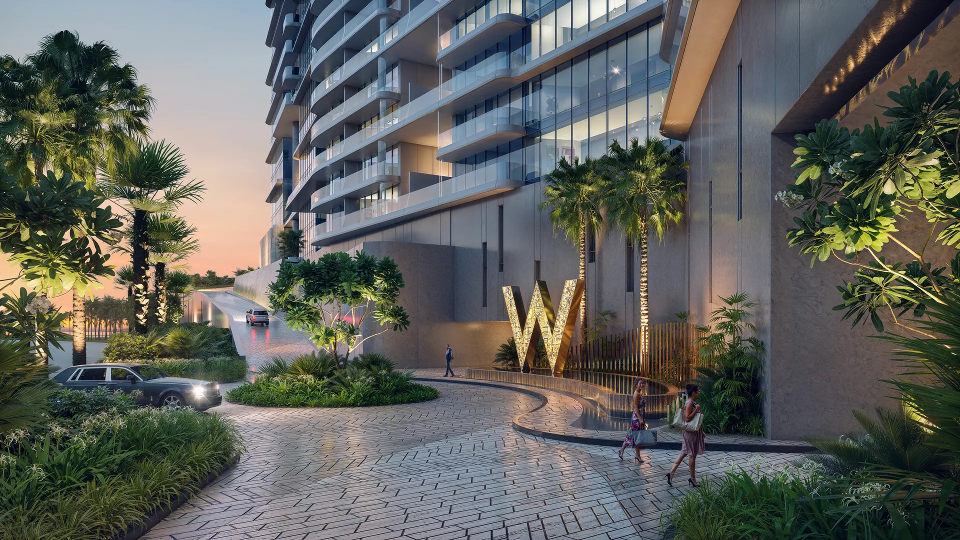 Entrada principal de W by Marriott en Al Marjan Island, con la W iluminada, palmeras y la torre de residencias al atardecer